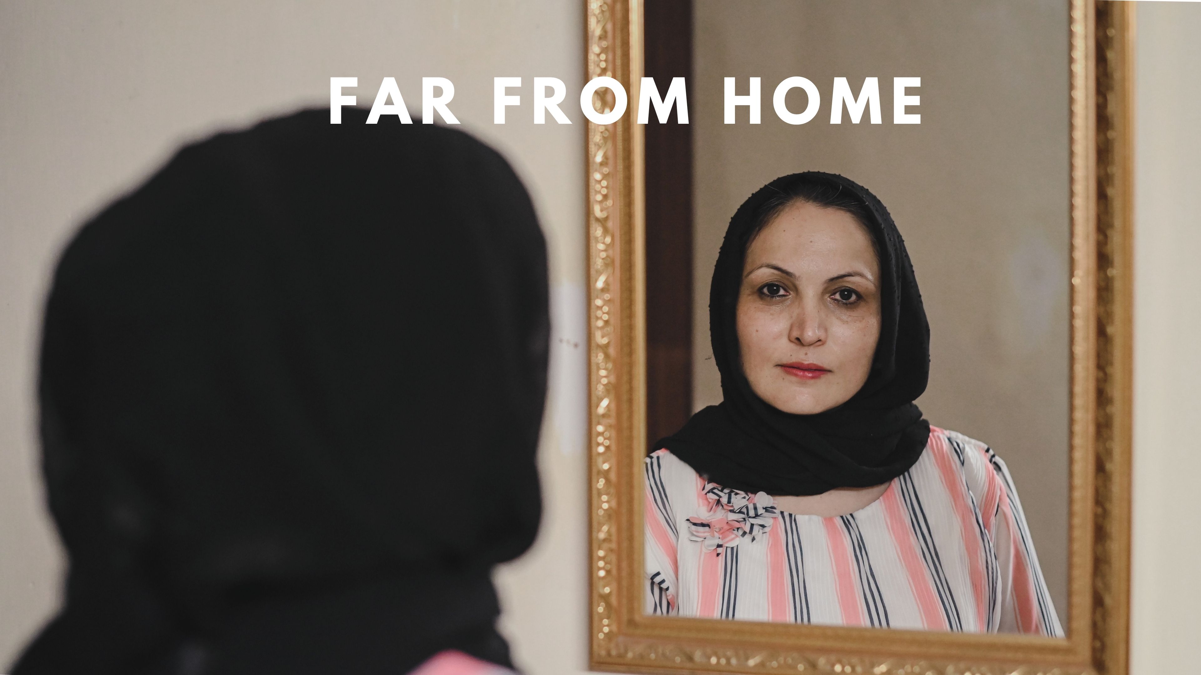 Far From Home An Afghan woman looking herself in a mirror