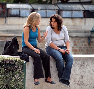 Image by Zoetnet of two women sitting on a cement wall in paris chatting